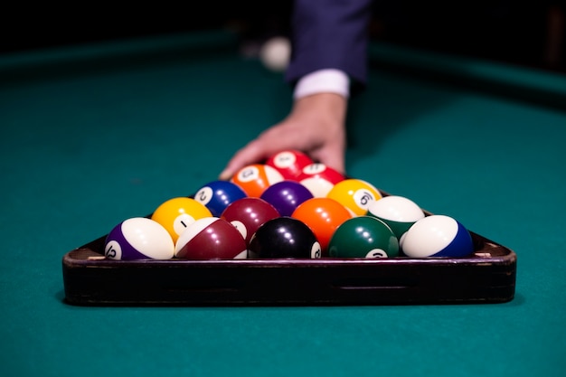 Close-up guy arranging pool balls