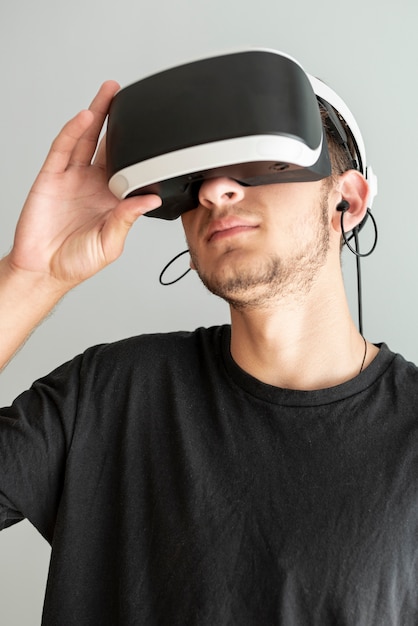 Close-up guy wearing virtual reality glasses