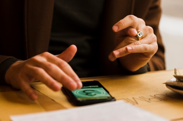 close-up guy with ring and smartphone