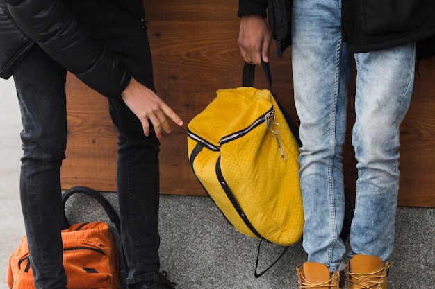 Free photo close-up guys with yellow backpack