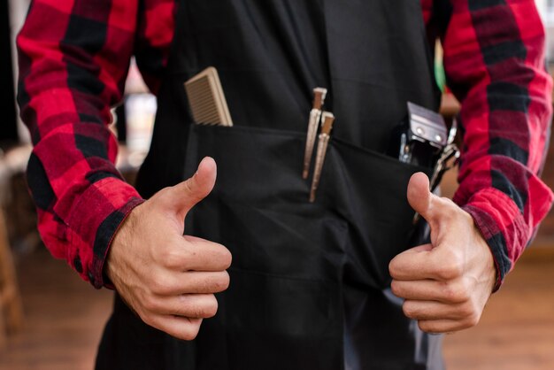 Close-up of haidresser showing thumbs up