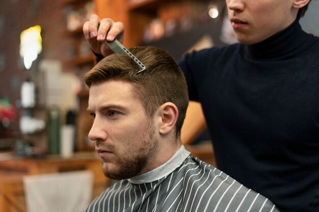 Close up hairdresser holding comb