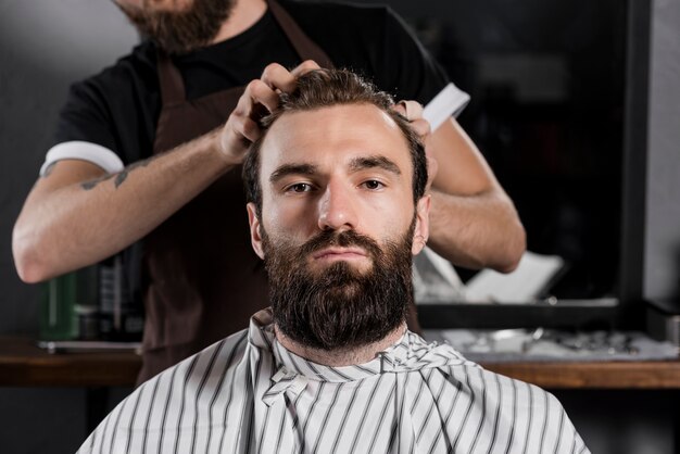 Close-up of a hairdresser styling man's hair