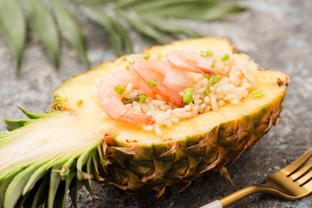 Close-up half of pineapple with shrimps