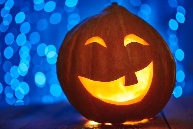 Close up of a Halloween pumpkin jack face lantern with candle light copyspace tradition autumn celebration scary spooky concept.