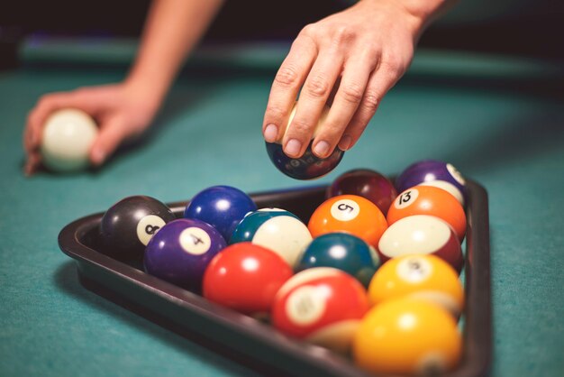 Close up on hand aiming to play pool game