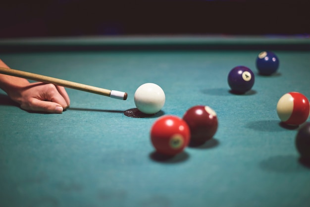 Close up on hand aiming to play pool game