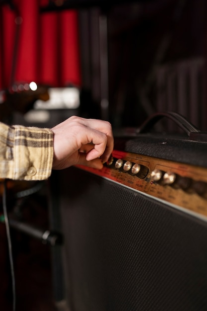 Close up hand and amplifier