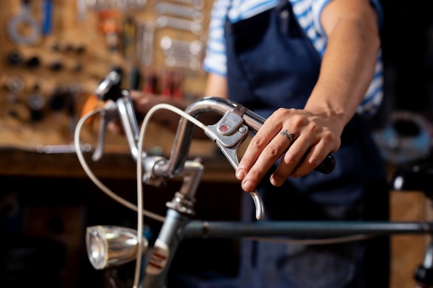 Close up hand checking bicycle