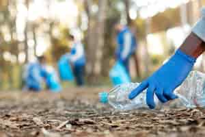 Free photo close up hand collecting bottle