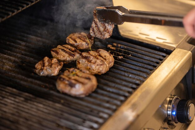 Close-up hand cooking meat