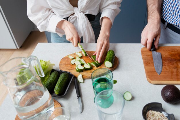 Close up hand cutting cucumber