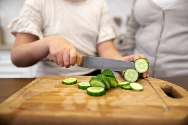 Close up hand cutting cucumber
