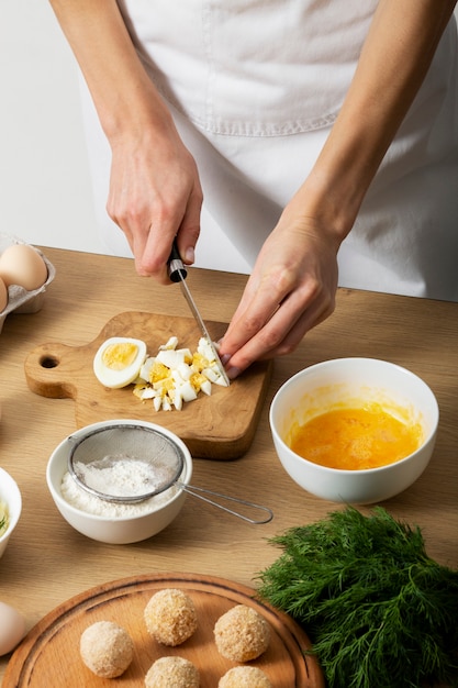 Free photo close up hand cutting eggs