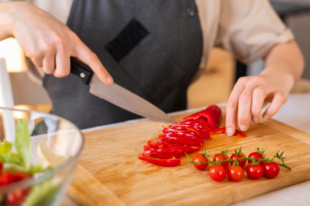 Close up hand cutting pepper