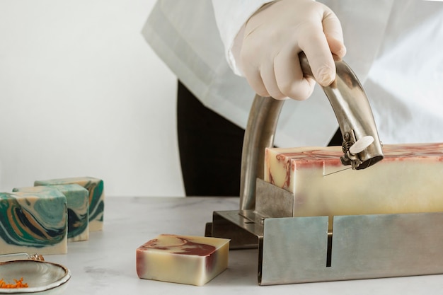 Close up hand cutting soap