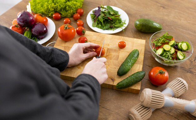 Close up hand cutting tomato