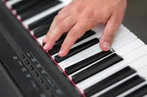 Free photo close-up hand on digital piano high view