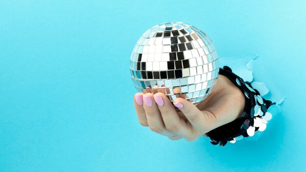 Close up hand and disco ball