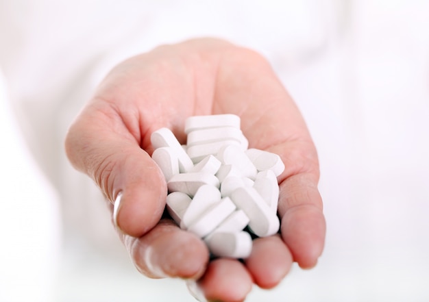 Close up of hand of a doctor with pills