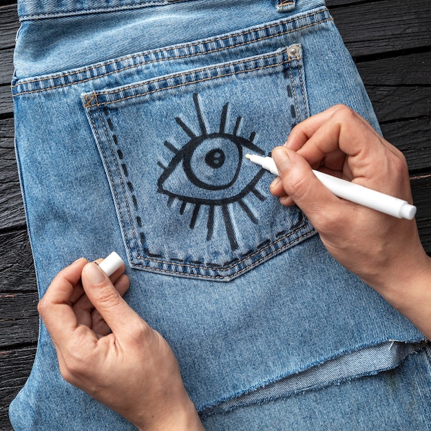 Close-up hand drawing on jeans