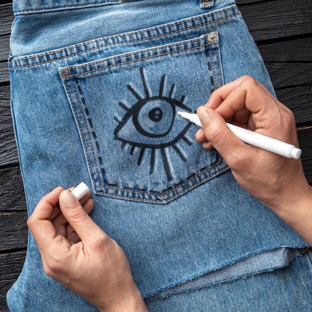 Close-up hand drawing on jeans