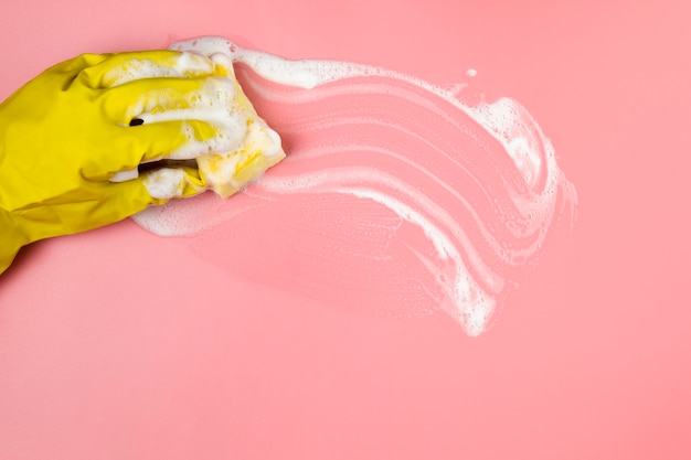 Close-up hand in glove cleaning surface