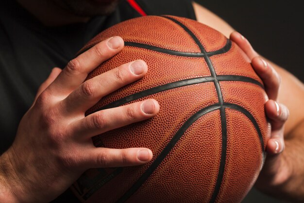 Close-up of hand held basketball