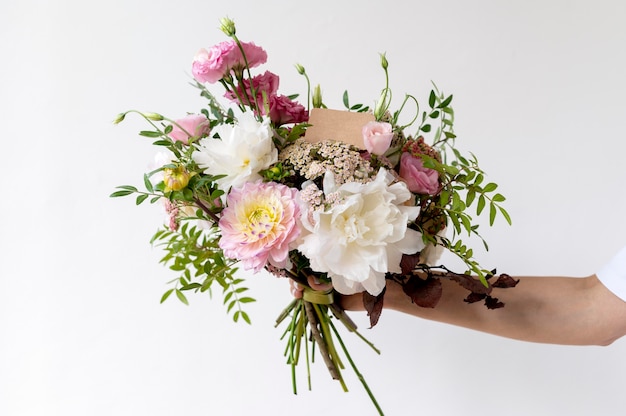 Close up hand holding beautiful flowers