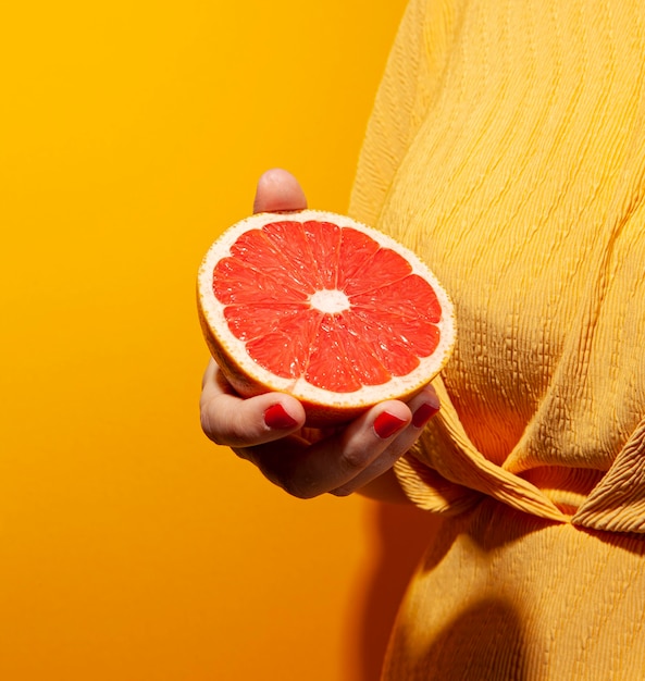 Free photo close-up hand holding blood orange