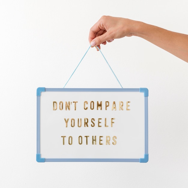 Free Photo close-up hand holding board with text