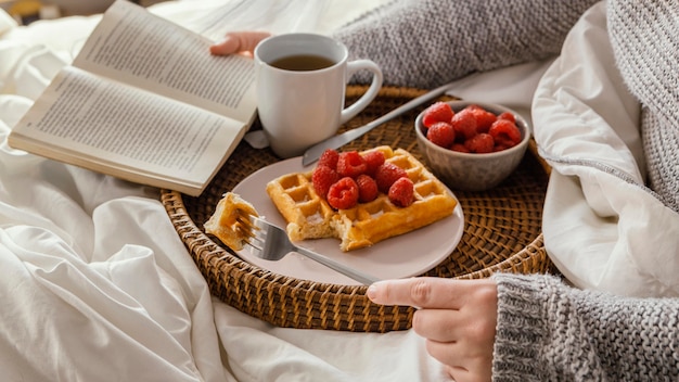 Close-up hand holding book and fork