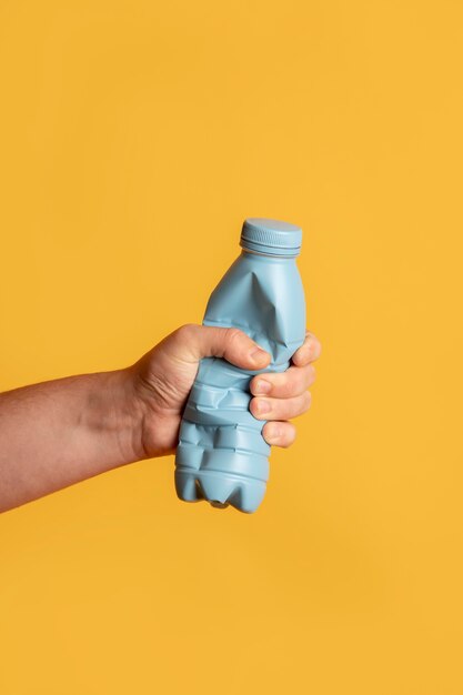 Close up hand holding bottle pet