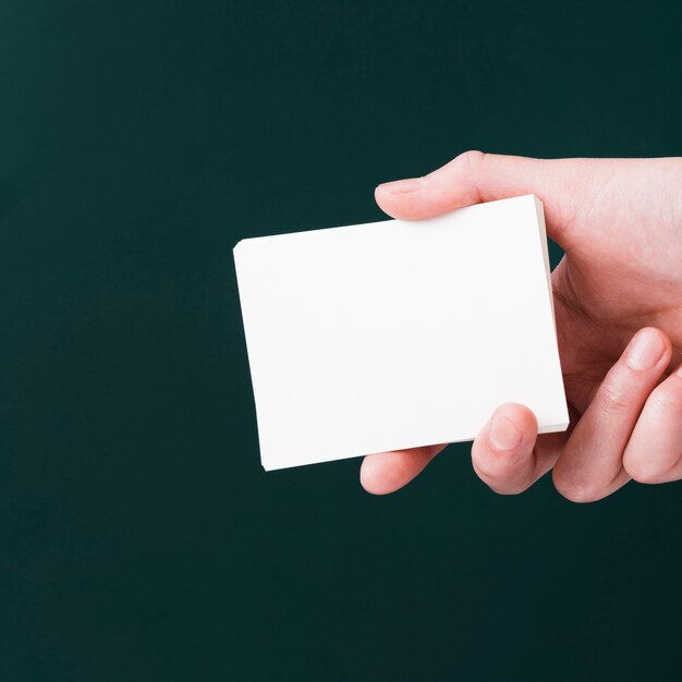 Close-up hand holding bunch of business cards