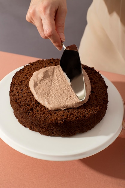 Close up hand holding cake spatula