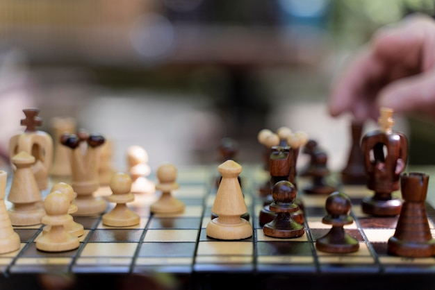 Close up hand holding chess piece