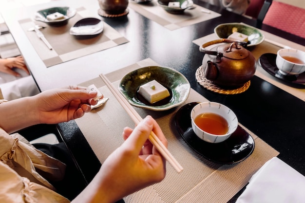 Close up hand holding chopsticks