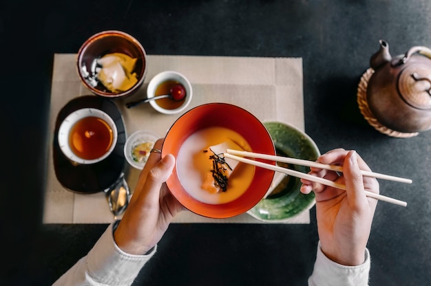 Close up hand holding chopsticks