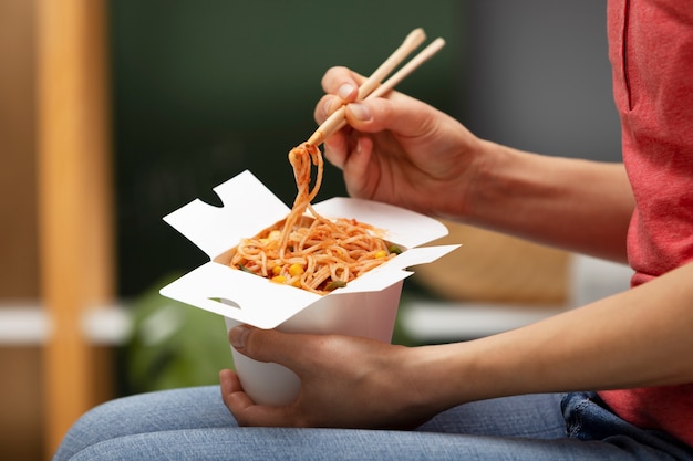 Close up hand holding chopsticks