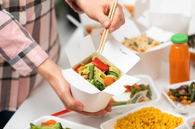 Close up hand holding chopsticks