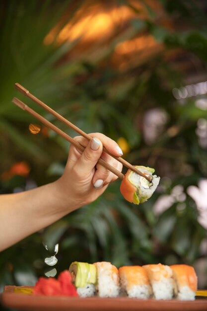 Close up hand holding chopsticks
