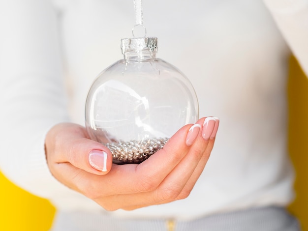 Free photo close-up hand holding christmas globe