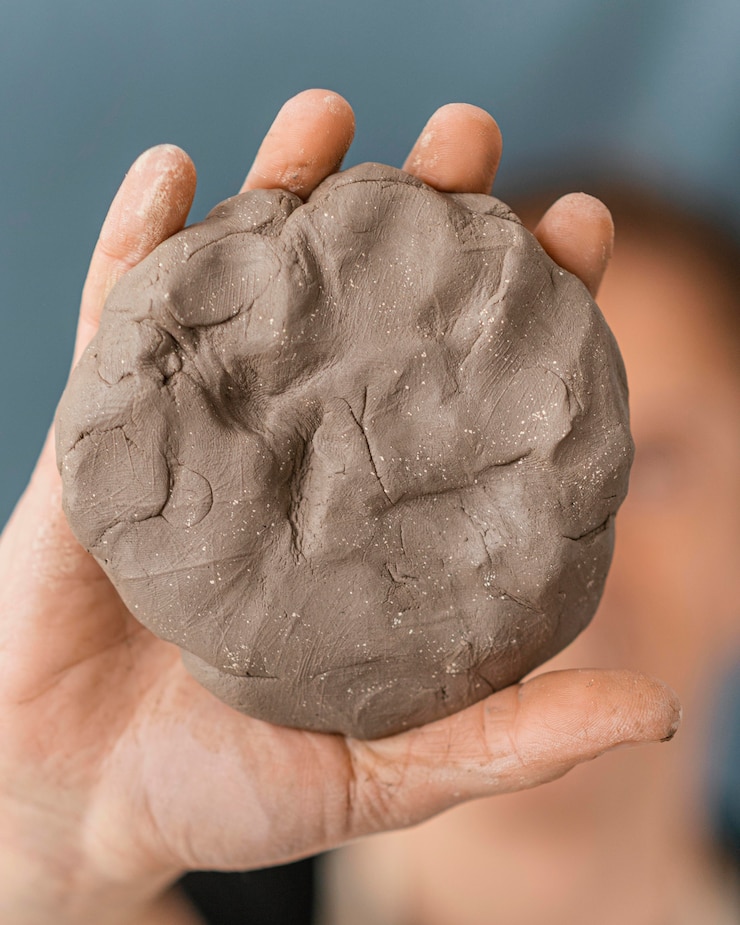 Free Photo close-up hand holding clay