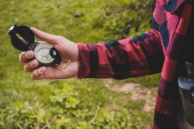 Close-up of hand holding a compass