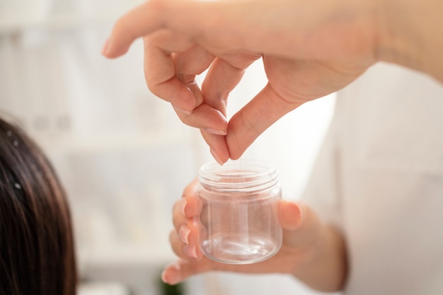 close up hand holding container