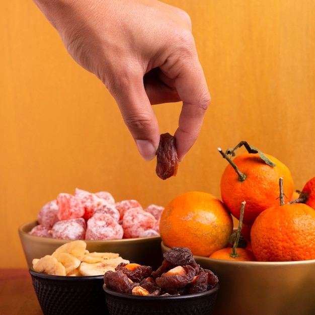 Close-up of hand holding dehydrated fruit for chinese new year