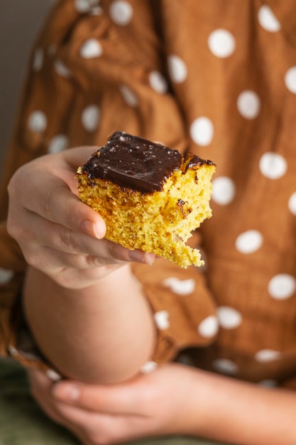 Close-up hand holding delicious cake