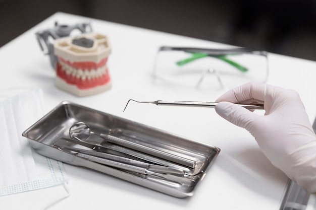 Close up hand holding dental equipment