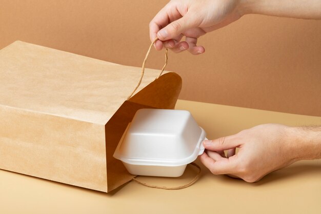 Close up hand holding food container