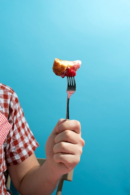 Close up hand holding fork